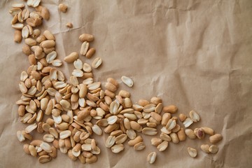 scattered peanuts laying on a piece of craft paper
