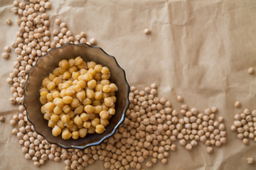 boiled and raw chickpea laying on craft paper