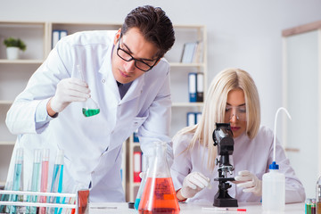 Two chemists having discussion in lab