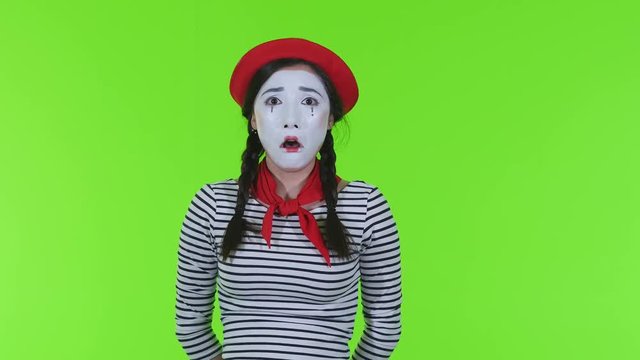 Crying girl mime on a green background