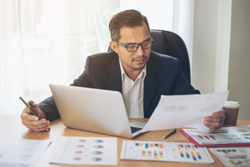 Business man busy standing at office desk  on documents  working  , business concept