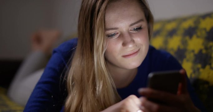 4K Young single woman using dating app on her smartphone, swiping left & right