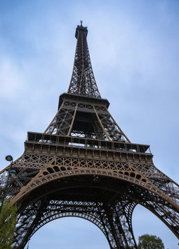 Eiffel tower captured in uprisen angle with blue sky in background in Paris, France.