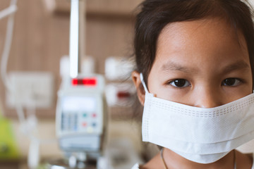 Sick asian little child girl wear protection mask while live in the hospital