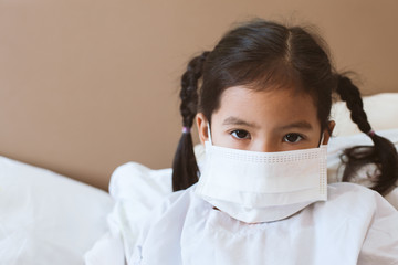 Sick asian little child girl wear protection mask while live in the hospital