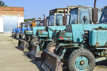 Fototapeta premium Tractor with a bucket for digging soil. Bulldozer and grader.