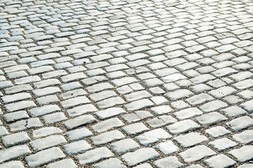 Road paved with cobble stones for your background