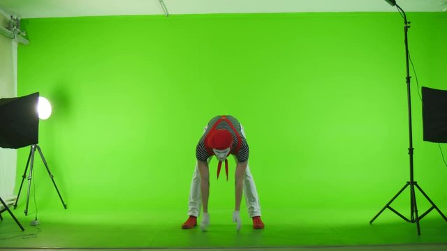 Mim athlete with a barbell on a green background
