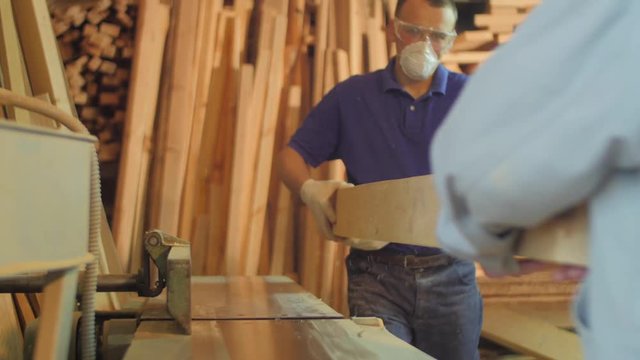 Men working with wood in a carpentry workshop