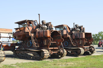 Old rusty disassembled combine harvester. - obrazy, fototapety, plakaty