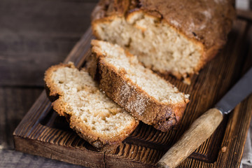 Fototapeta na wymiar Homemade cinnamon cake bread on rustic wooden board on background table