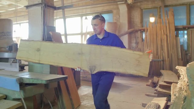 Carpenter taking a wood plank