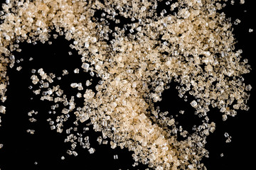 Crystals Sugar,Brown cane sugar isolated on black background