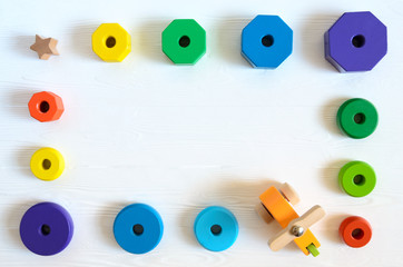 Fototapeta premium Learning developmental kids toys. Shape sorter, geometric stacker, organic wooden baby toys. Flat lay, top view. Copy space