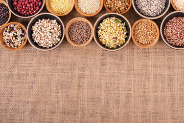 Variety of rice and grains in bowls on linen tablecloth