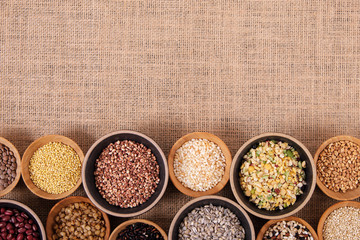 Variety of rice and grains in bowls on linen tablecloth