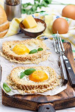 Toast with baked egg, cheese, spices and Basil. Breakfast