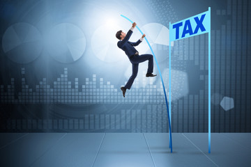 Fototapeta na wymiar Businessman jumping over tax in tax evasion avoidance concept