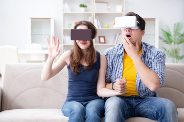Young family playing games with virtual reality glasses