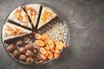 product set and cut carrot cake on the dish on gray concrete backdrop