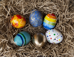Fototapeta na wymiar Easter colorful eggs in the nest, close-up.
