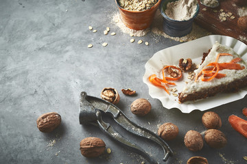 product set and piece carrot cake on the dish on gray concrete backdrop
