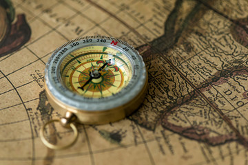 Old compass on vintage map