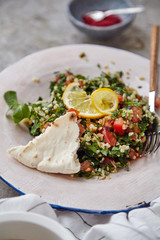 Image of traditional jewish and middle eastern food tabouli witn fresh mint, parsley and tomatoes. Israeli cuisine concept
