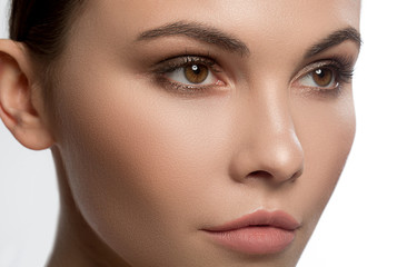 Close up of face of serious young woman looking forward with confidence. Beauty concept