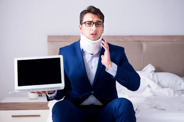 Businessman with neck injury working from home