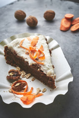 product set and cut carrot cake on the paper dish on gray concrete backdrop