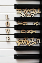 Piano keys closeup with the letters love and the heart. The original art image with valentine.
