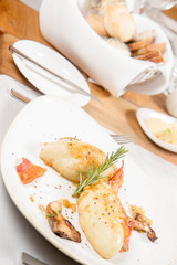 Traditional polish dish called kartacz - potato dumplings stuffed with meat and served with crispy bacon, caramelized onion and fried boletu