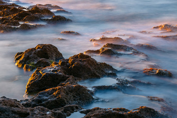 Obraz premium long exposure of sea and rocks at sunset