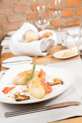 Traditional polish dish called kartacz - potato dumplings stuffed with meat and served with crispy bacon, caramelized onion and fried boletu