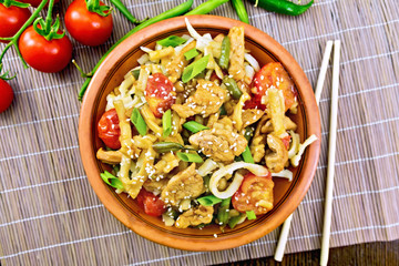 Noodles wok Thai in plate on bamboo top