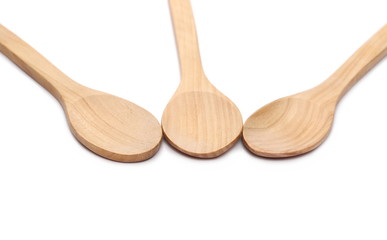 Empty wooden spoons isolated on white background