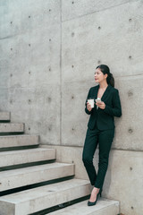 business manager standing outside taking break