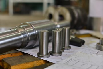 metal industry. finishing shaft surface on grinder machine