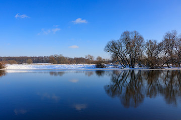 Water surface of the winter river against blue sky. Winter landscape