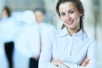 Business lady with positive look and cheerful smile posing