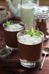 Chocolate mousse in glasses with coconut and mint