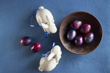 Two easter bunnies on blue background.