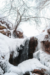Fototapeta na wymiar Landscape with the image of cascade in winter