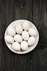 White eggs on a rustic wooden background
