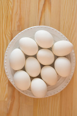 White eggs on a wooden background