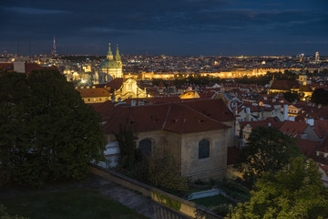Shot across rooftops and skyline of Prague at dusk.