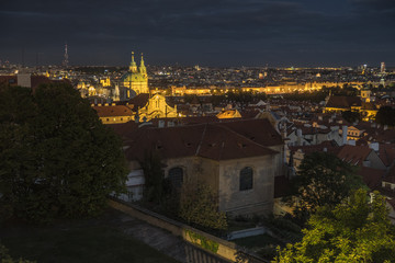 Shot across rooftops and skyline of Prague at dusk.