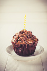 Chocolate muffins or capkakes on a white table