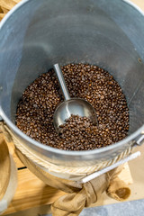 Arabica coffee in bucket tank with scoop